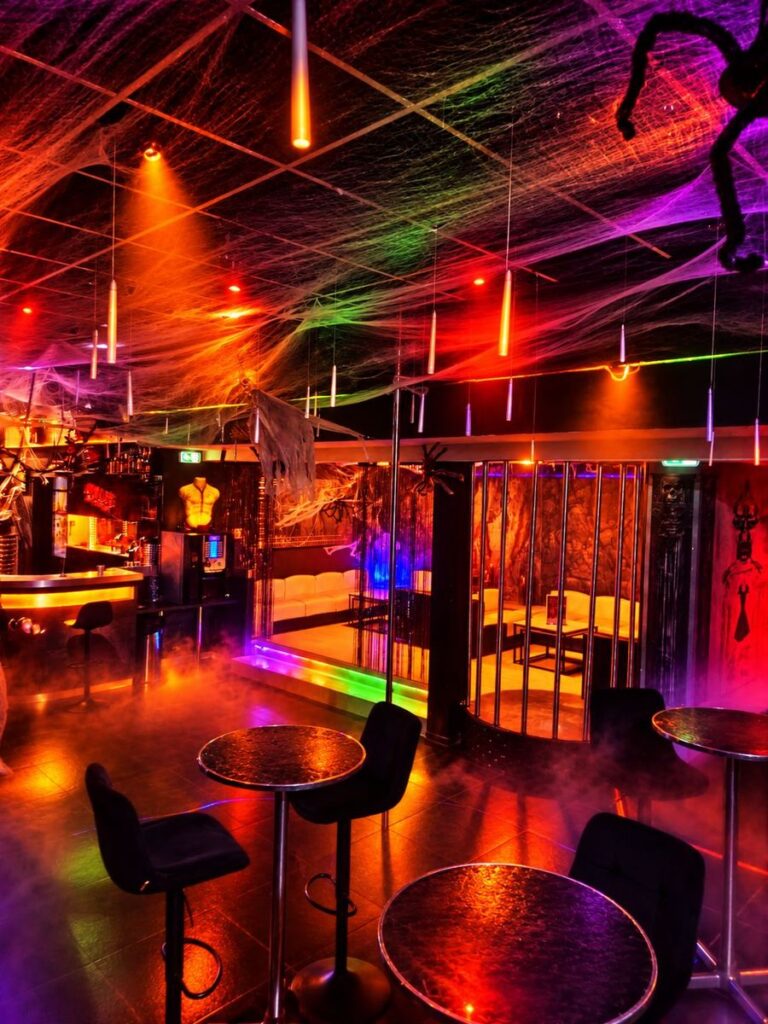 Cages et banquettes blanches sous un plafond de toiles d’araignée